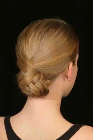 an updo created by a fishtail braided ponytail