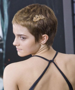 Emma Watson with pixie crop wearing hair accessories to dress up her hair