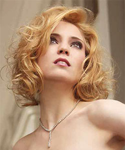 medium to short curly hair style above shoulder in gold blonde
