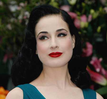 Dita Von Teese with her signature look and beautiful black hair color and bold red lips