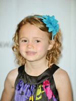 little girl with curly hair decorated with a headband