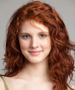 model with wavy long hair and red hair color