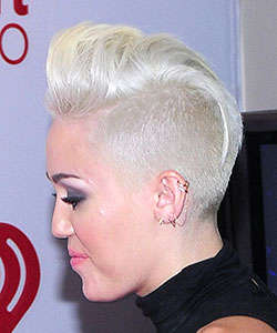 Miley Cyrus with same mohawk haircut in overall silver color