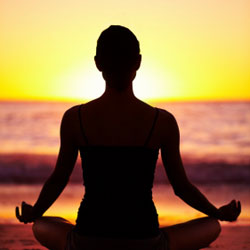 Doing Yoga at beach in sunset